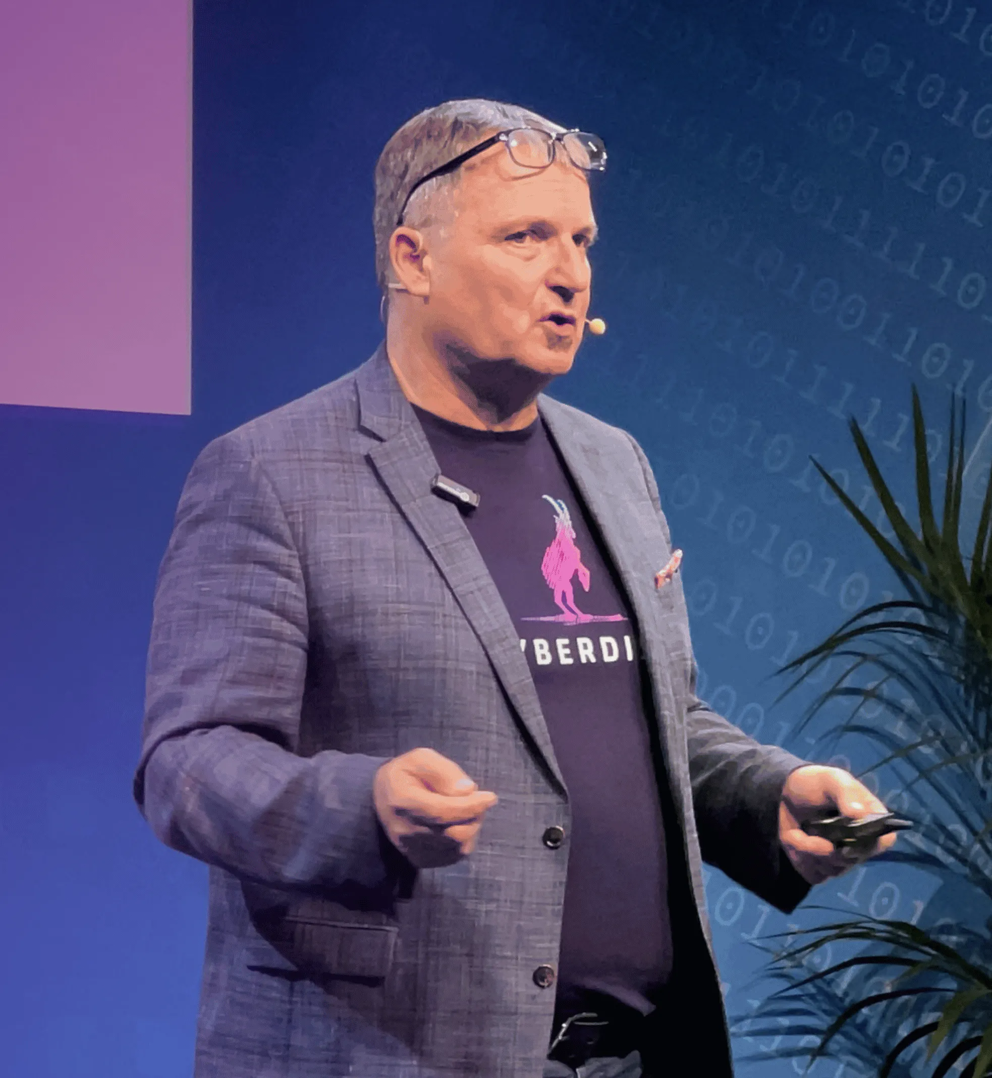 Speaker in a Cyberdise T-shirt presenting on a trade-fair stage