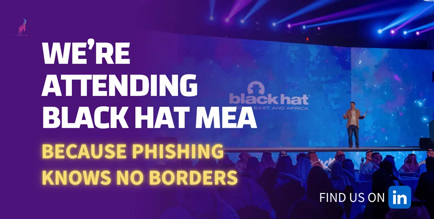 Banner «We're attending Black Hat MEA – because phishing knows no borders» über einem Redner auf der Black-Hat-Bühne.